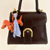 oranje teckel bag charm met lichtblauwe tassel - VERKOCHT